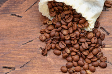 coffee beans on a wooden background scattered