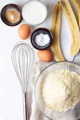 ingredients for baking with banana on white background.
