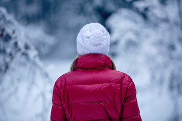 Woman on snowy forest path