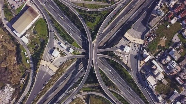 Aerial drone top view video of highway junction multi level overpass passing through city centre