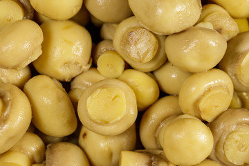 Food background of marinated mushrooms. Pickled champignons close-up