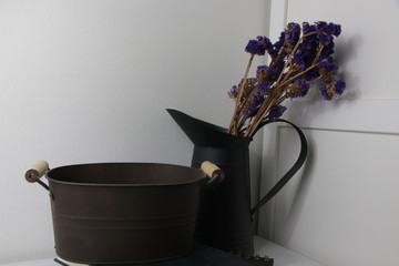 Dried Purple Flowers in Balck Metal Vase on White Background