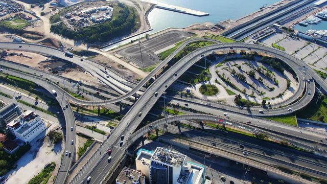 Aerial drone video of curve multilevel motorway junction near the sea