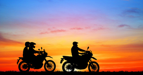 Fototapeta na wymiar silhouette of lover couple and friend in sunset with classic motorcycle