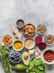 Healthy clean food - vegetables, fruits, nuts, superfoods on a gray background. Healthy eating concept. Top view.