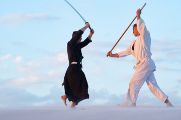 Concentrated men, in Japanese clothes, are practicing martial art