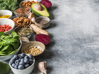 Healthy clean food - vegetables, fruits, nuts, superfoods on a gray background. Healthy eating concept.