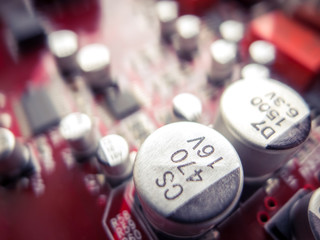 Circuit board in red with electronic components. Electronic circuit board. 