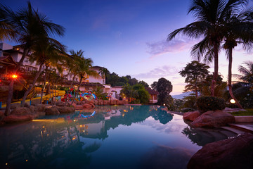 Sunset and romantic atmosphere sky on swimming pool side in Pangkor island . Beautiful travel...