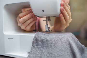 Naklejka premium Woman working with the machine for sewing. Sewing Process 