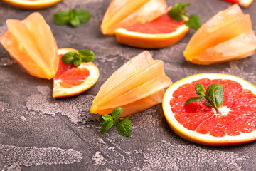 Homemade grapefruit popsicle with ripe grapefruit slices and fresh mint