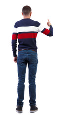 Fototapeta premium Back view of man in sweater shows thumbs up.