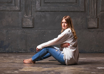 Fashion shoot of young sexy woman in blue jeans