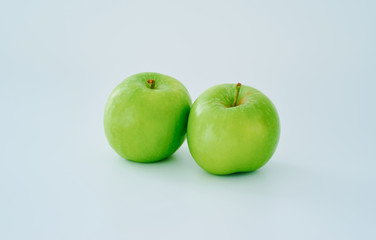 Two green apple on white background .