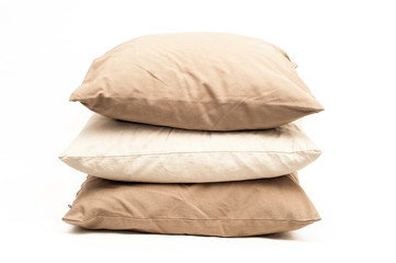 Fototapeta na wymiar Three beige pillows on a white background. Burlap pillow cases