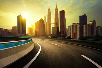 Highway overpass motion blur with city background . - obrazy, fototapety, plakaty