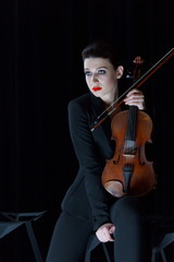 violin and girl playing, cello on dark background, red lips, brunette