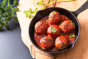 Food Homemade organic spicy meatball in iron cast on wooden background