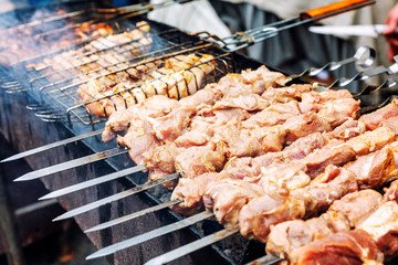 Raw chunks of meat are roasted over charcoal