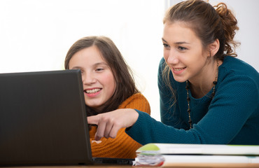 Fototapeta na wymiar young woman helps a teen girl with homework