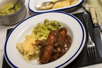  mashed potato, onion gravey, grilled sausages and mushy peas