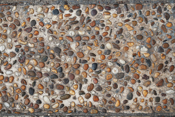 pile of colored pebble stones on cement floor