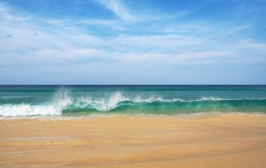 Fototapeta na wymiar Ocean wave on a sandy beach in Thailand