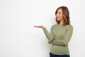 young happy woman presenting your product on thie background