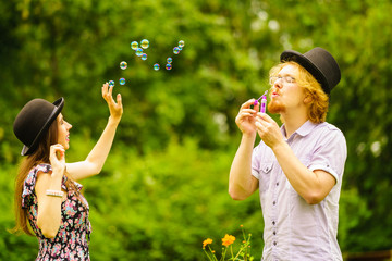 Couple blowing bubbles outdoor