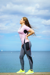 Woman exercising next to sea