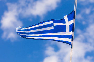 Greek flag waving against blue sky