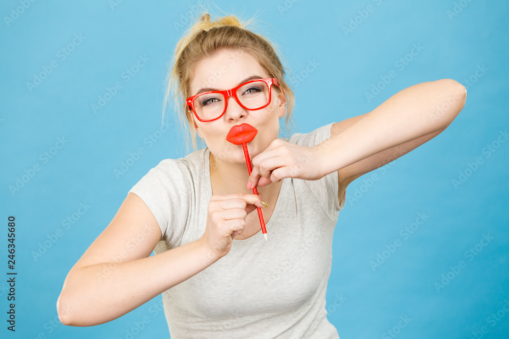 Poster Happy woman holding fake lips on stick