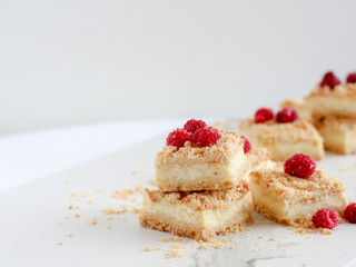 Sliced crumble pie with raspberries on top with copy space