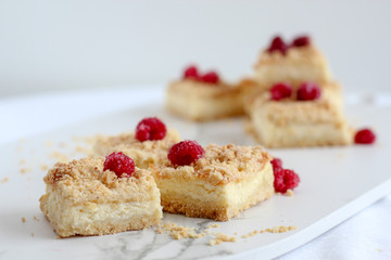 Sliced crumble pie with raspberries on top