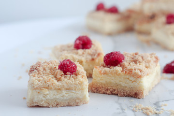 Sliced crumble pie with raspberries on top, close up