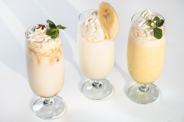 Delicious milkshake drinks. Healthy nutrition concept. Glasses set on white background.