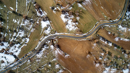 Aerial view of road in the nature winter time. Winding road. 