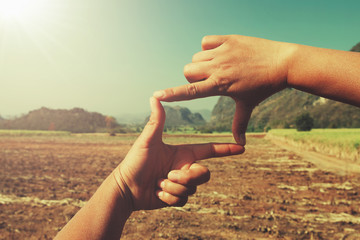close up hand framing view distant