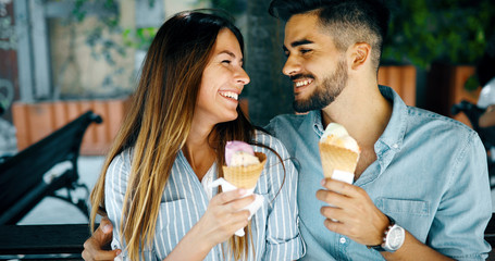 Happy couple having date and eating ice cream
