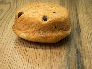 Chocolate chip brioche on wood background