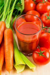 Glass of different vegetable juices with carrots, tomatoes and c