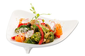Spring vegetable salad. Peppers, carrots, broccoli and radishes. On white background
