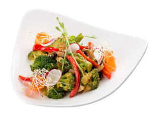 Spring vegetable salad. Peppers, carrots, broccoli and radishes. On white background