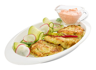 Zucchini pancakes with sauce on a white plate