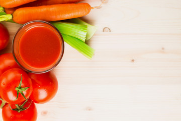 Glass of different vegetable juices with carrots, tomatoes and c