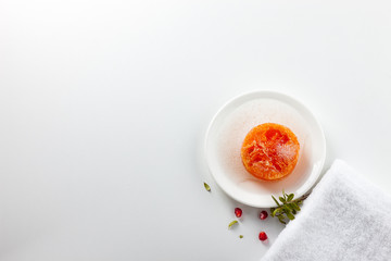 Handmade soap on a white background. Pomegranate-scented skin care. Spa treatments and aromatherapy for smooth and healthy skin.