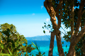 Sea, islands and rocks in the blue water and sky