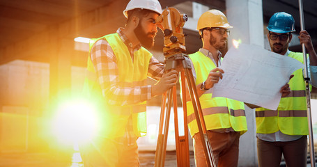 Team of construction engineers working on building site