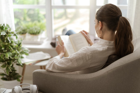 Woman relaxing and reading a book