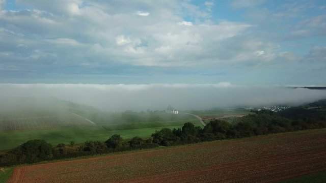 Aerial view of St. Rochus Chapel in the vineyards near Nittel with fog, Obermosel, Moselle Valley, Rhineland-Palatinate, Germany